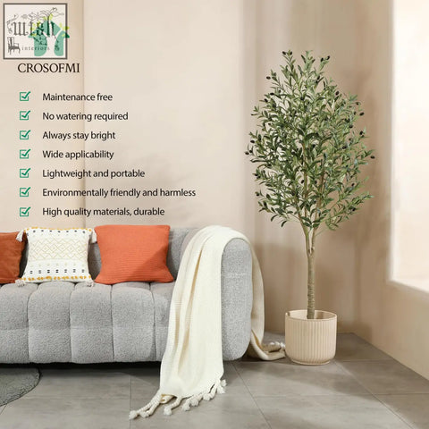 A tall artificial olive tree with green leaves and dark olives in a beige ribbed pot for indoor decor