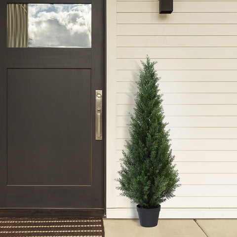 Dark green artificial cedar tree in a black plastic pot perfect for outdoor garden or porch decoration