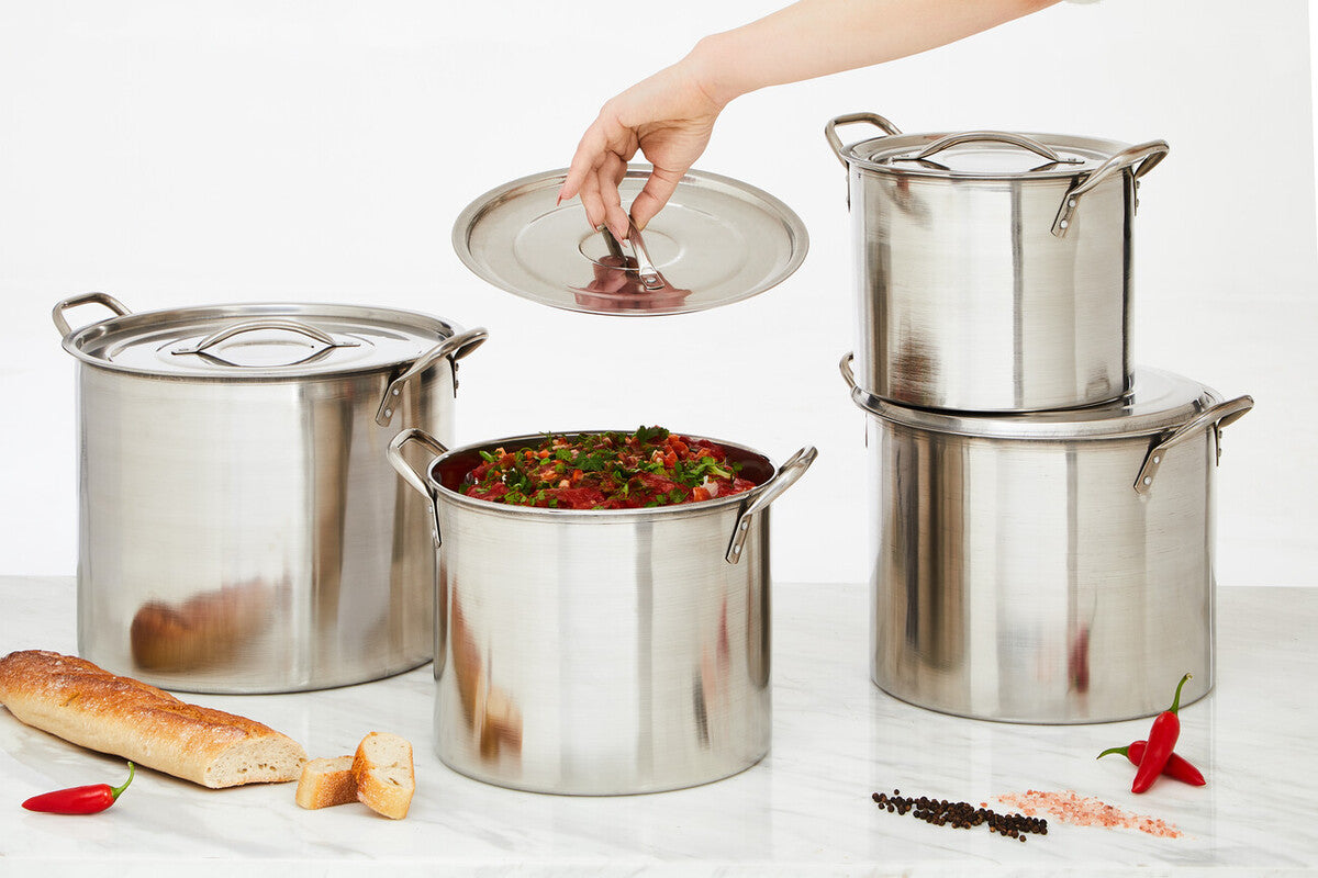 Set of 4 classic silver crosse stainless steel stock pots with lids one open showing red and green stew inside