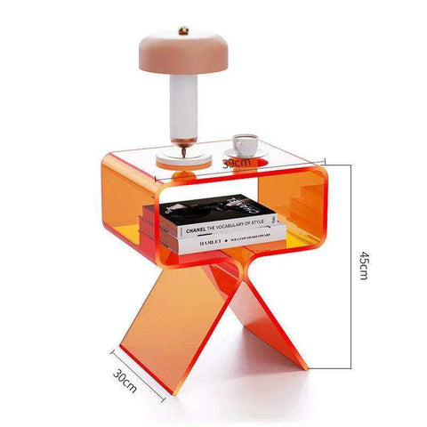 Transparent orange crystal acrylic side table with sleek modern x-shaped base and glass top