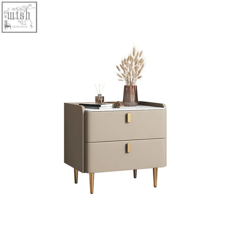 Beige cunha bedside table with two drawers gold-tone handles and legs topped with white marble surface
