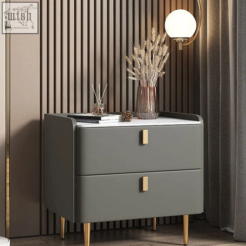 Modern gray cunha bedside table with two drawers gold-tone legs rectangular handles and white top surface