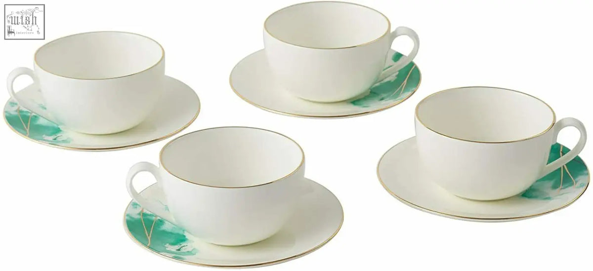 Set of four white premium porcelain teacups with gold banding and green botanical patterns on matching saucers