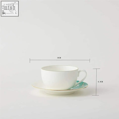 A white premium porcelain teacup and saucer set with gold banding and mint green leaf patterns holding 200ml