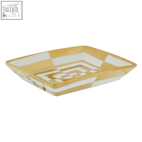 A rectangular curva ceramic gold and white dish with a geometric pattern perfect as a white dish centerpiece