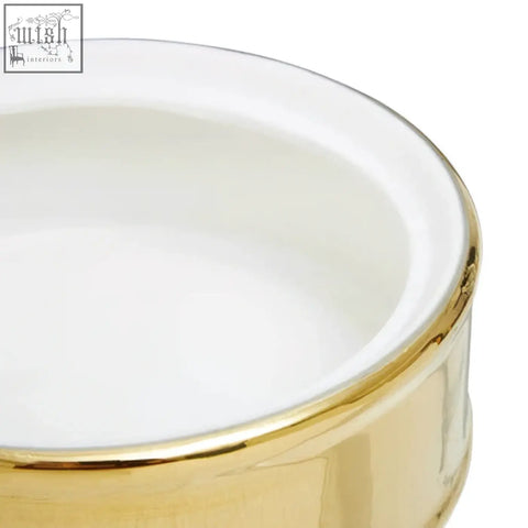 A white ceramic trinket box with a shiny gold rim perfect as a stylish white trinket box for small items