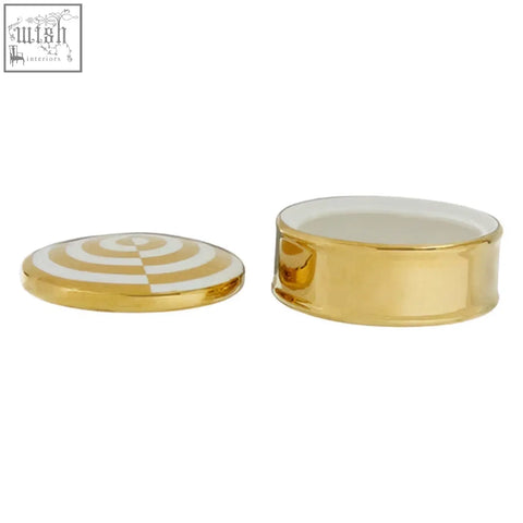 Gold-colored ceramic round trinket box with white and gold concentric stripes and a matching lid white trinket box