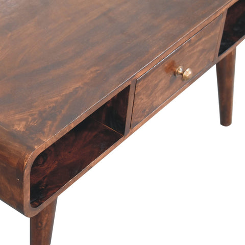 Curved california walnut coffee table with dark brown wood, curved front, single drawer, brass knob, and tapered legs