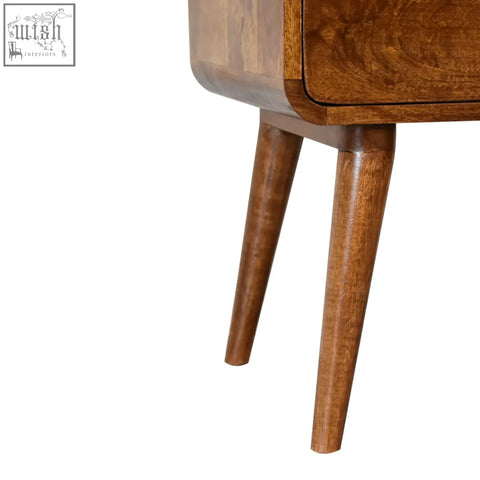 A warm medium brown curved chestnut bedside table with smooth finish and tapered legs perfect for bedroom use