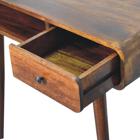 Curved chestnut writing desk with rustic dark brown wooden finish and a single drawer with black metal knob
