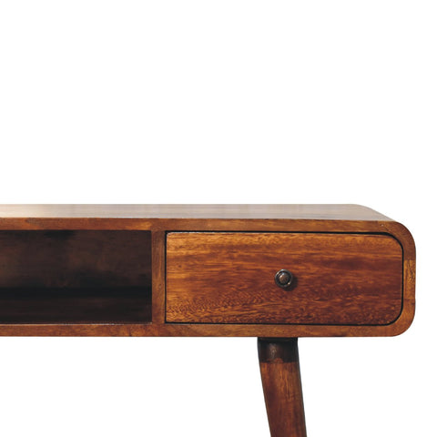 Curved chestnut writing desk with a warm medium-toned wood surface, single drawer, and dark metal knob