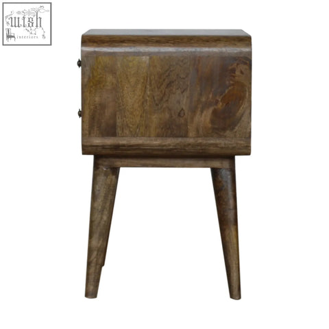 A rustic wooden bedside table with a grey washed finish, curved top, tapered legs, and warm brown grain patterns