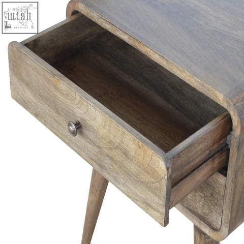 A rustic wooden bedside table with a single drawer and slender tapered legs in a grey washed finish