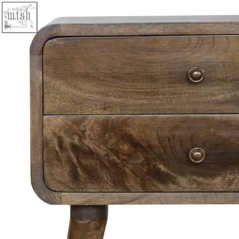 A rustic wooden two-drawer bedside table with a grey washed finish and brass-colored round knobs