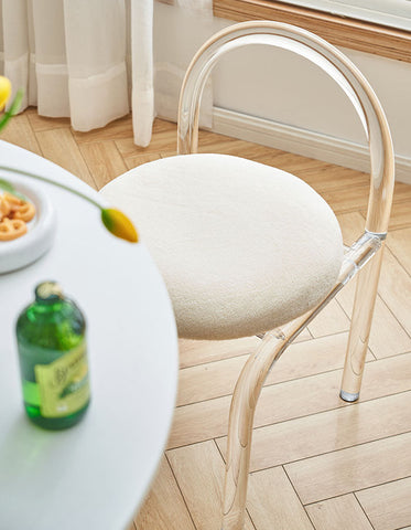 Curved clear plastic dressing table chair with clear acrylic frame and soft off-white cashmere seat pad