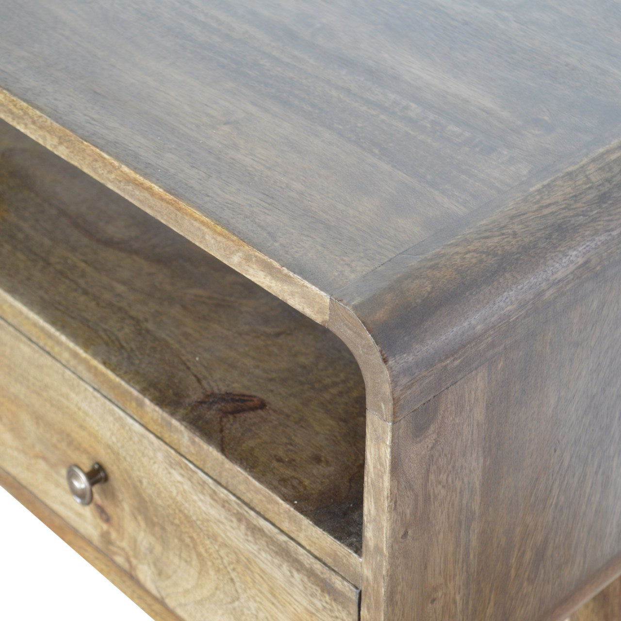 Gray-wash wooden console table with curved corner and single drawer featuring a metallic knob for storage