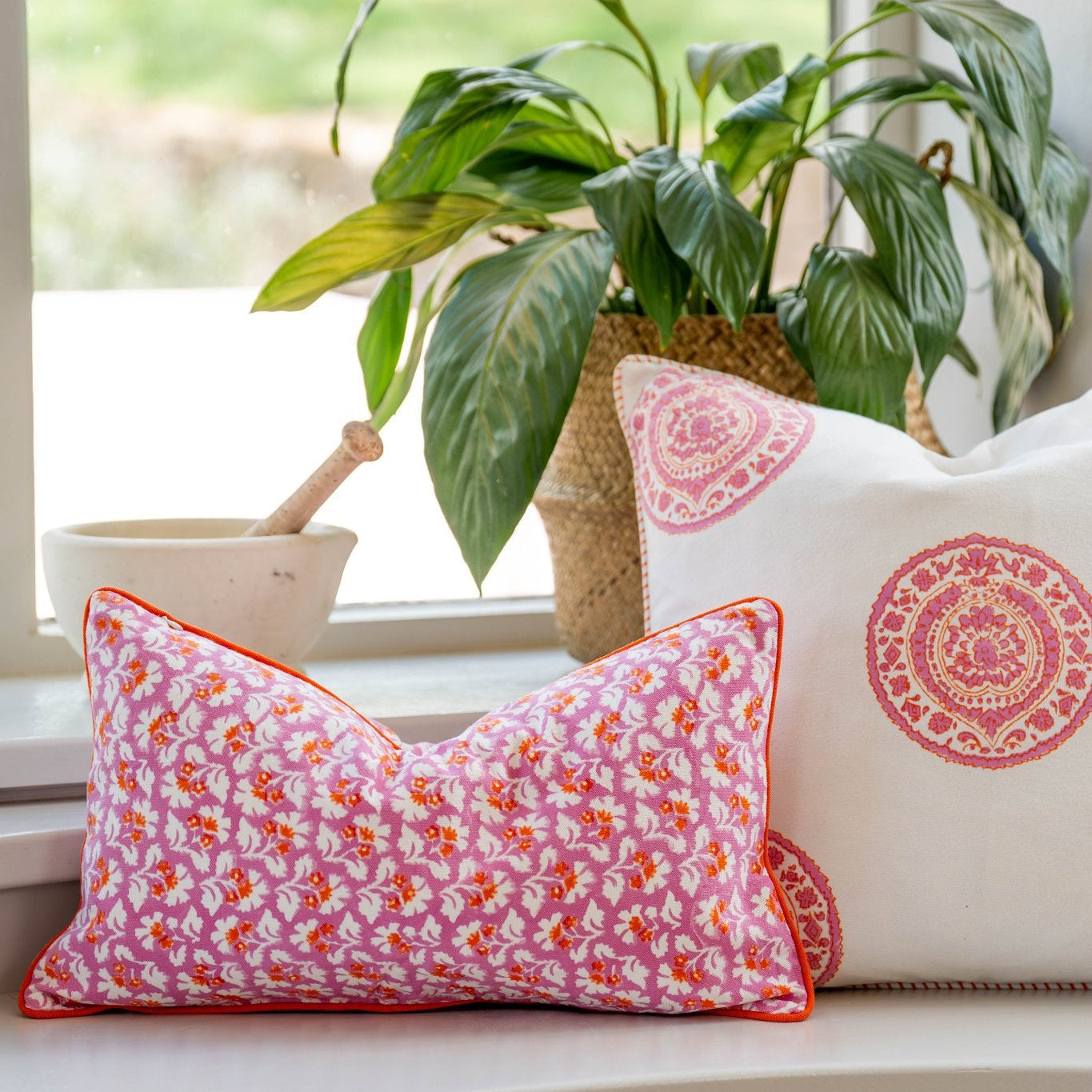 Pink floral hand block cushion cover with burnt spice orange trim perfect for cozy home decor