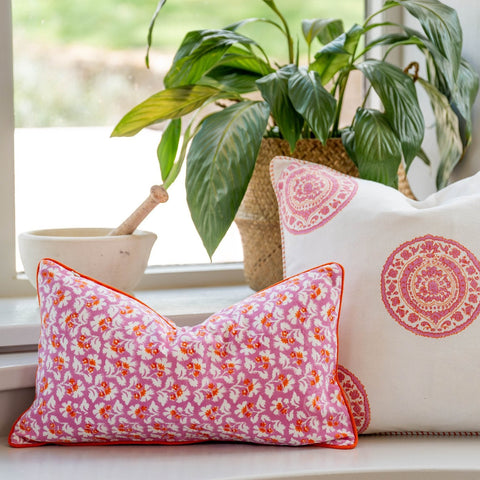 Pink floral hand block cushion cover with burnt spice orange trim perfect for cozy home decor