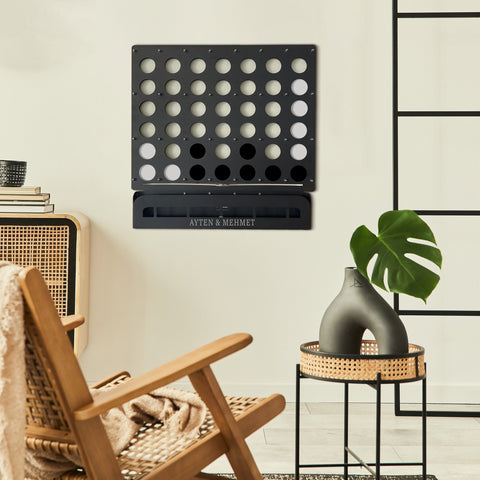 Customized black metal connect four wall game with engraved ayten and mehmet on the base for personalized play
