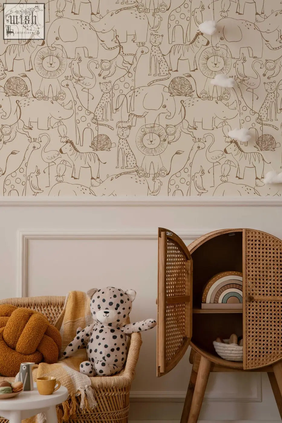 A plush white teddy bear with black polka dots on a wicker chair complements monochrome kids wallpaper from contact clickwalls
