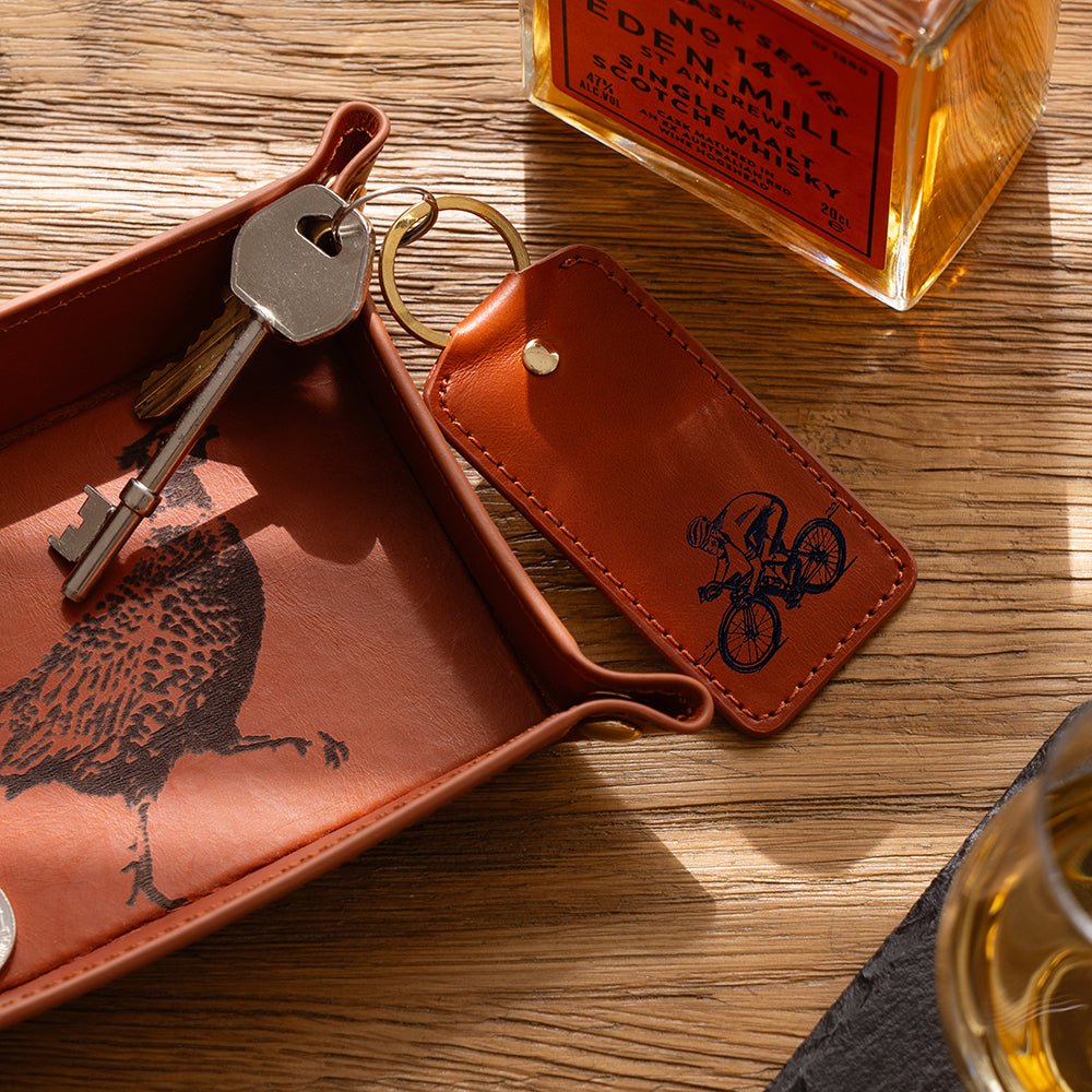 Brown leather keyring cycling leather keyring with pheasant print tray and engraved cyclist key fob by selbrae house