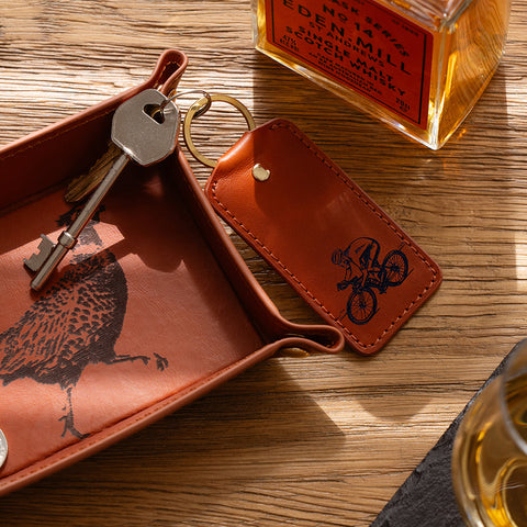 Brown leather keyring cycling leather keyring with pheasant print tray and engraved cyclist key fob by selbrae house