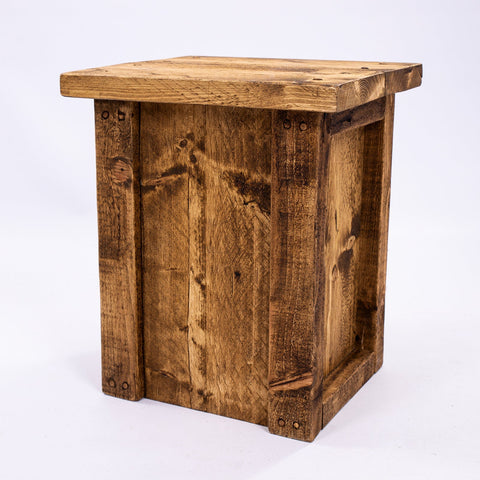 Rustic brown reclaimed wood side table with visible grain and nail holes for dining room or bar stool seating