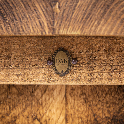 Antique-style brass plaque with black filigree and purple beads on dab chic vintage bar stool for dining room use