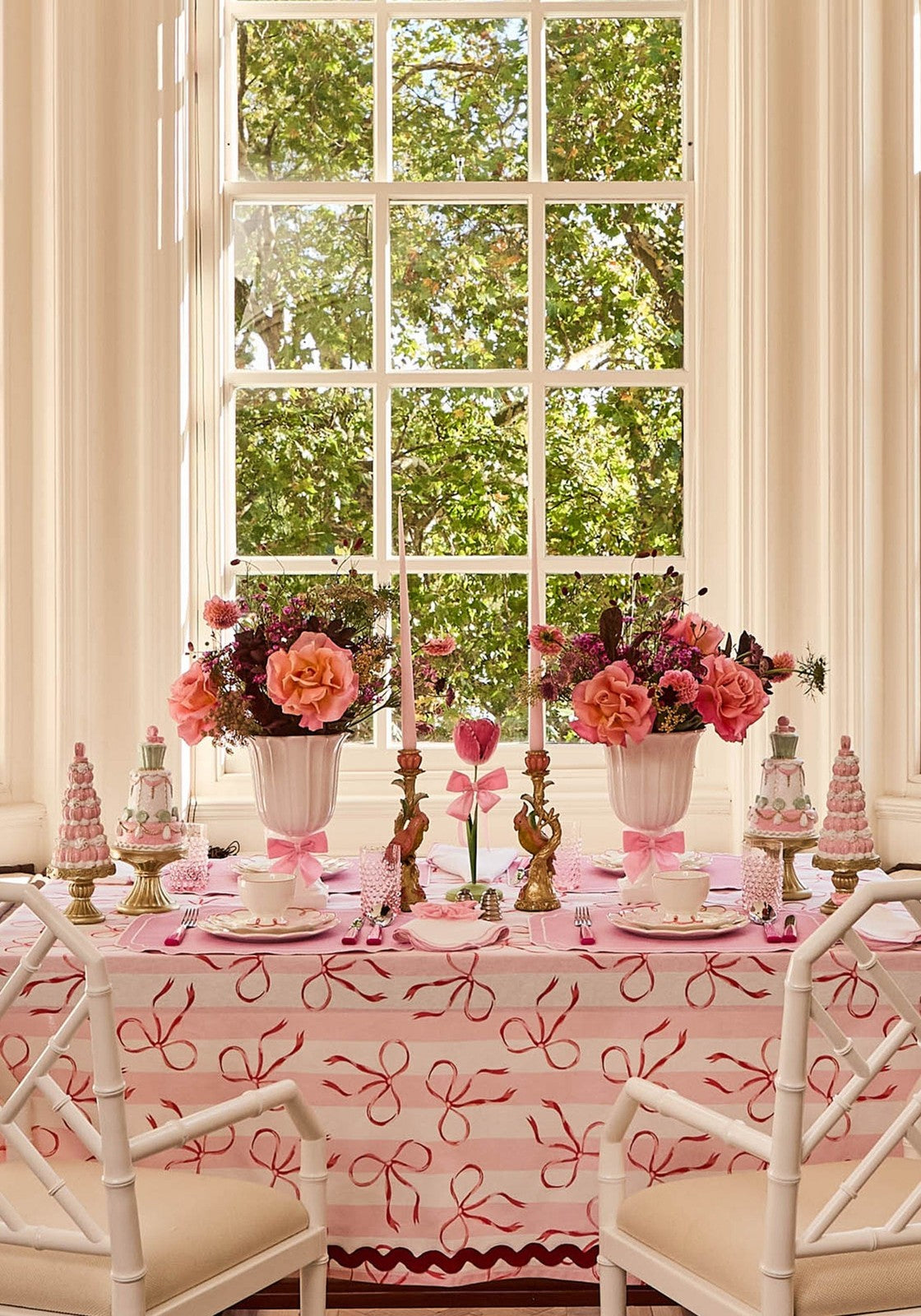 Dahlia pink petal candleholder tole with pink ribbon tablecloth white bamboo chairs and pink floral centerpieces