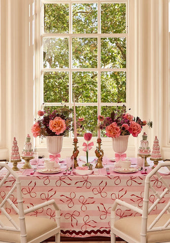 Dahlia pink petal candleholder tole with pink ribbon tablecloth white bamboo chairs and pink floral centerpieces
