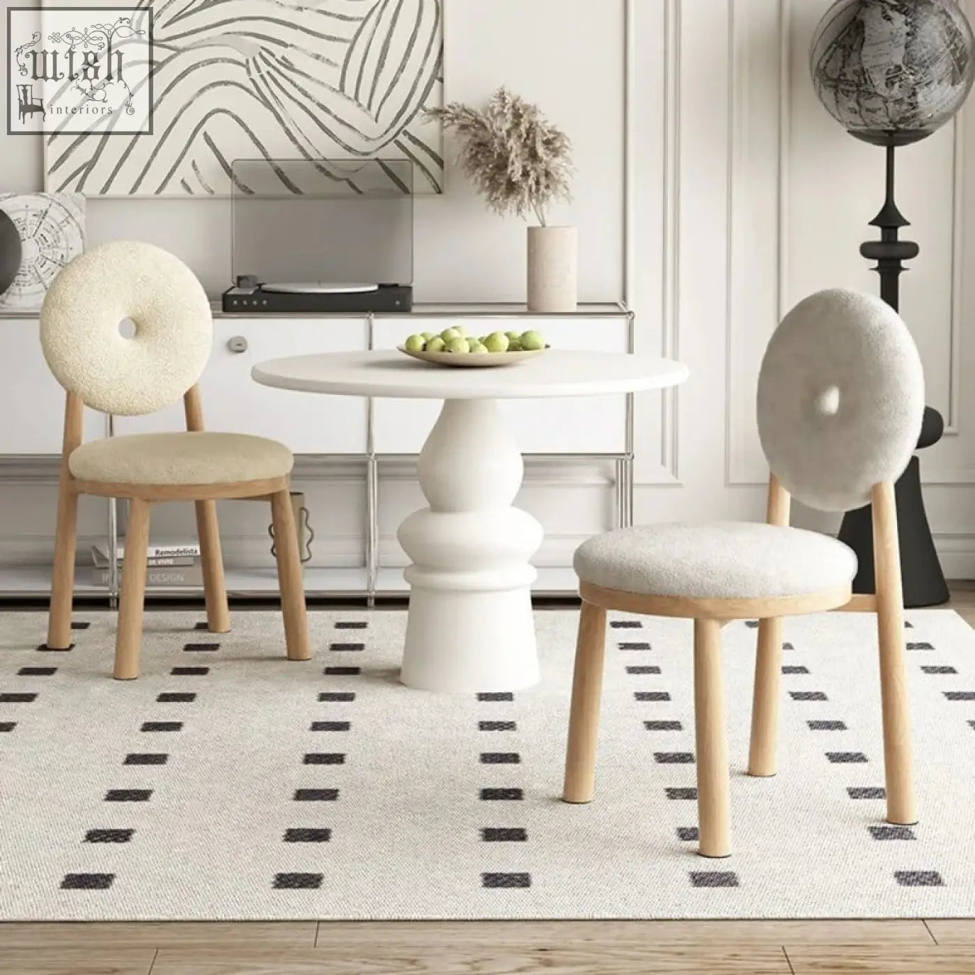 Cream-colored daiki chair with round donut-shaped backs and light wood legs upholstered in faux lamb wool