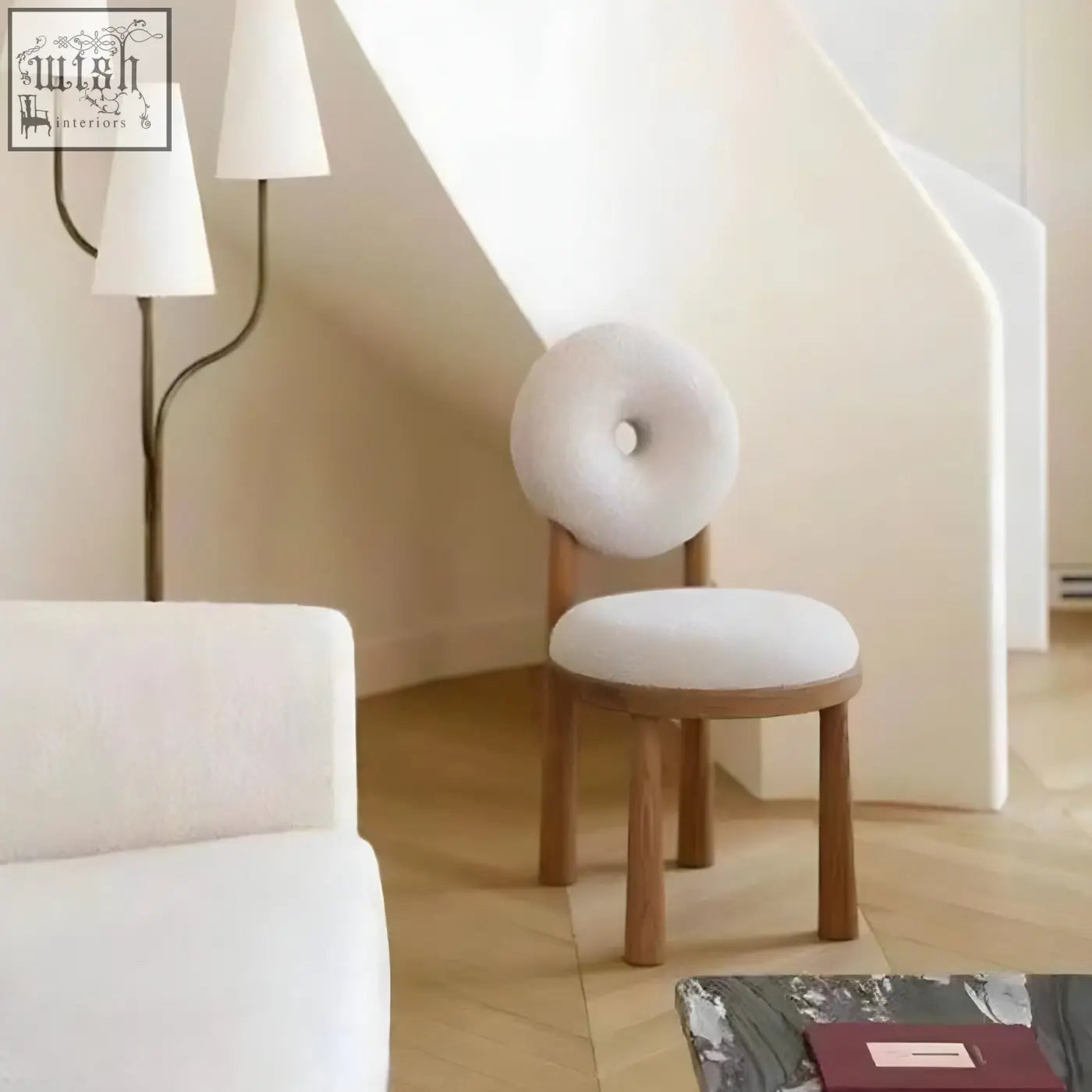 Daiki chair with minimalist white faux lamb wool upholstery and donut-shaped backrest on wooden legs