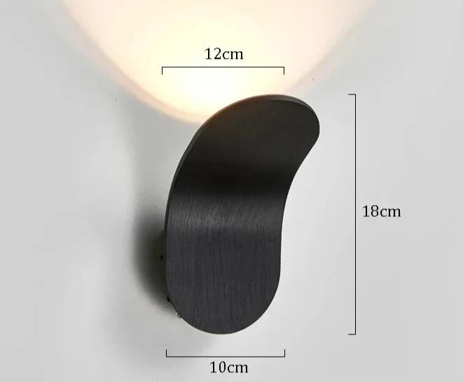 Black matte finished wall lights with sleek curved design mounted on wall called Daisuke Light