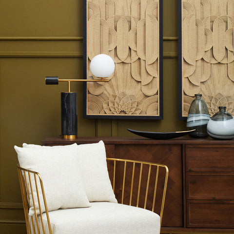 Gold-toned metal chair with white upholstery paired with daito black and gold boat dish for stylish dining