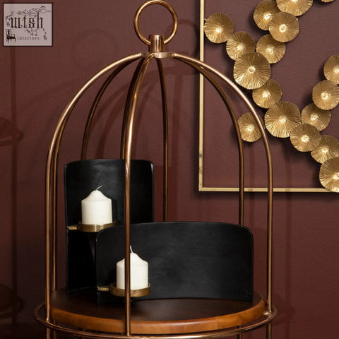 Daito black and gold finish candle holder features a gold-toned metal birdcage design with black leather accents and two white candles