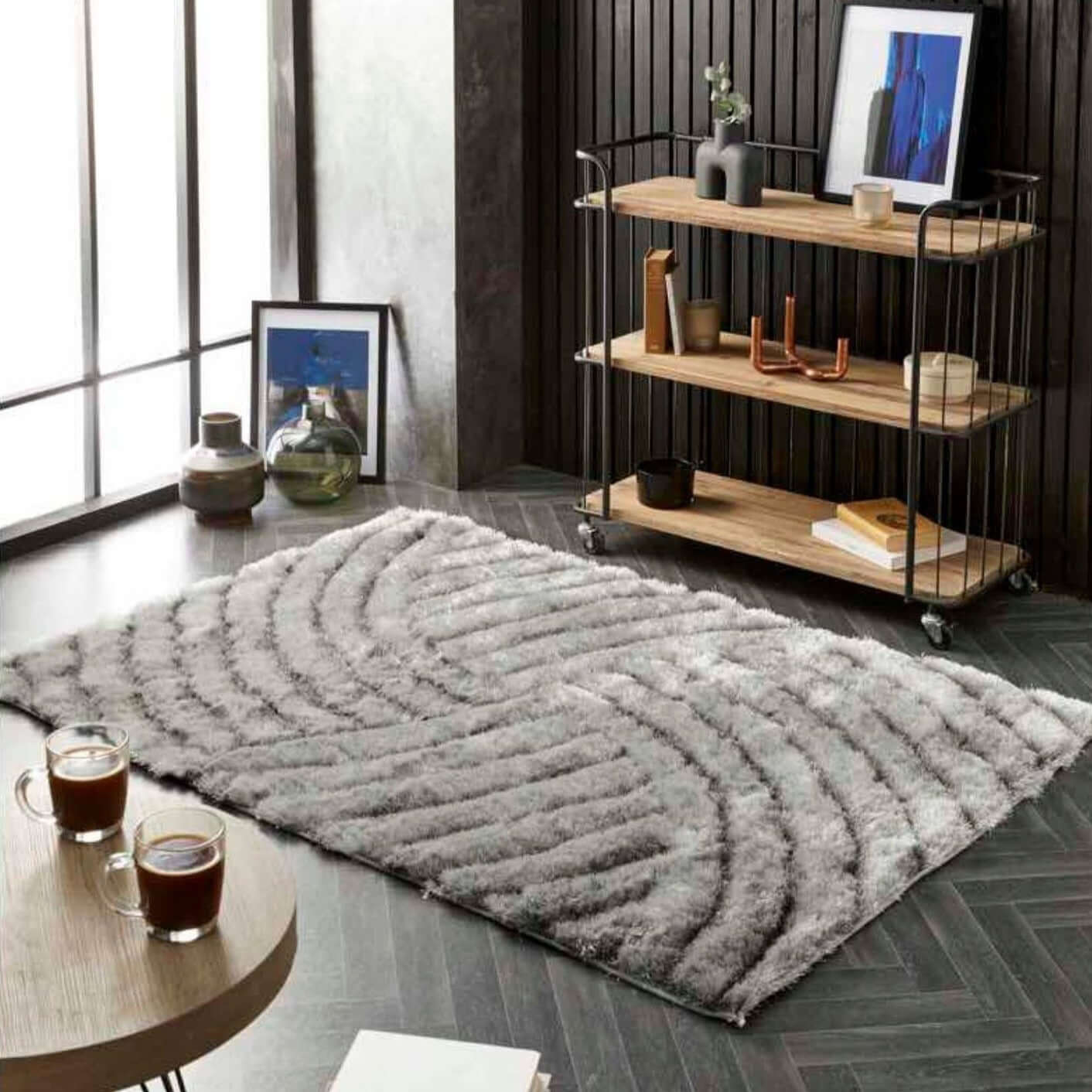 A plush dallas silver grey shaggy rug with a wavy textured pattern in soft silver grey tones on the floor