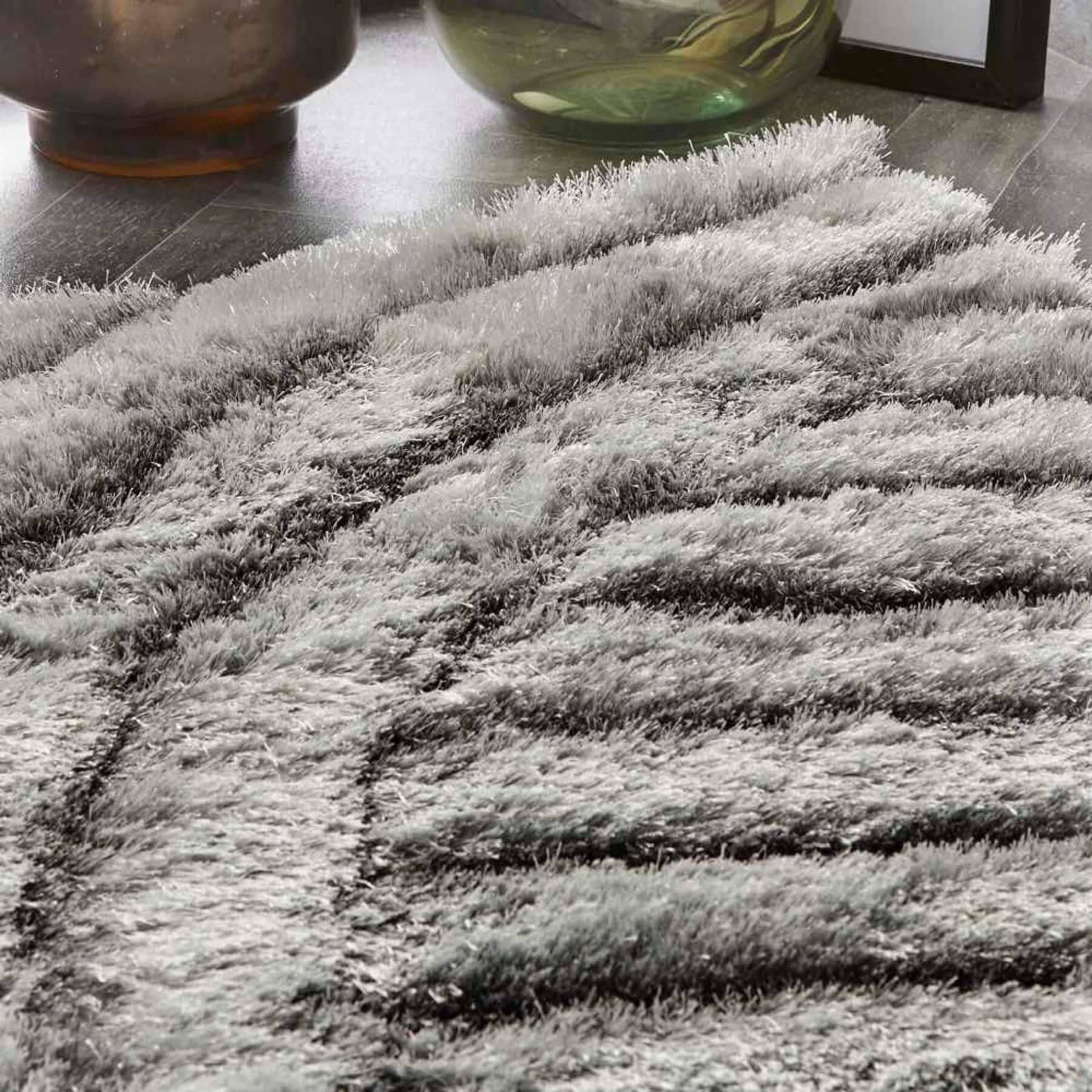 A plush dallas silver grey shaggy rug with thick silver grey fibers and a textured wave-like pattern