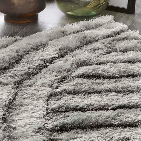 A plush dallas silver grey shaggy rug with thick silver grey fibers and a textured wave-like pattern