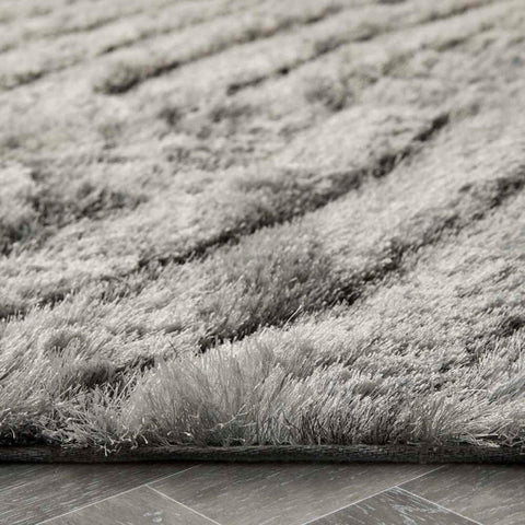 A dallas silver grey shaggy rug with a plush, textured wave-like pattern and dense soft pile in silver grey color