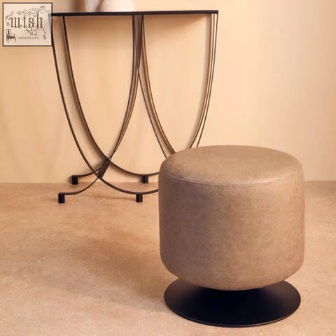 Beige round ottoman with black base in ash grey faux leather pouffe style for stylish seating and decor