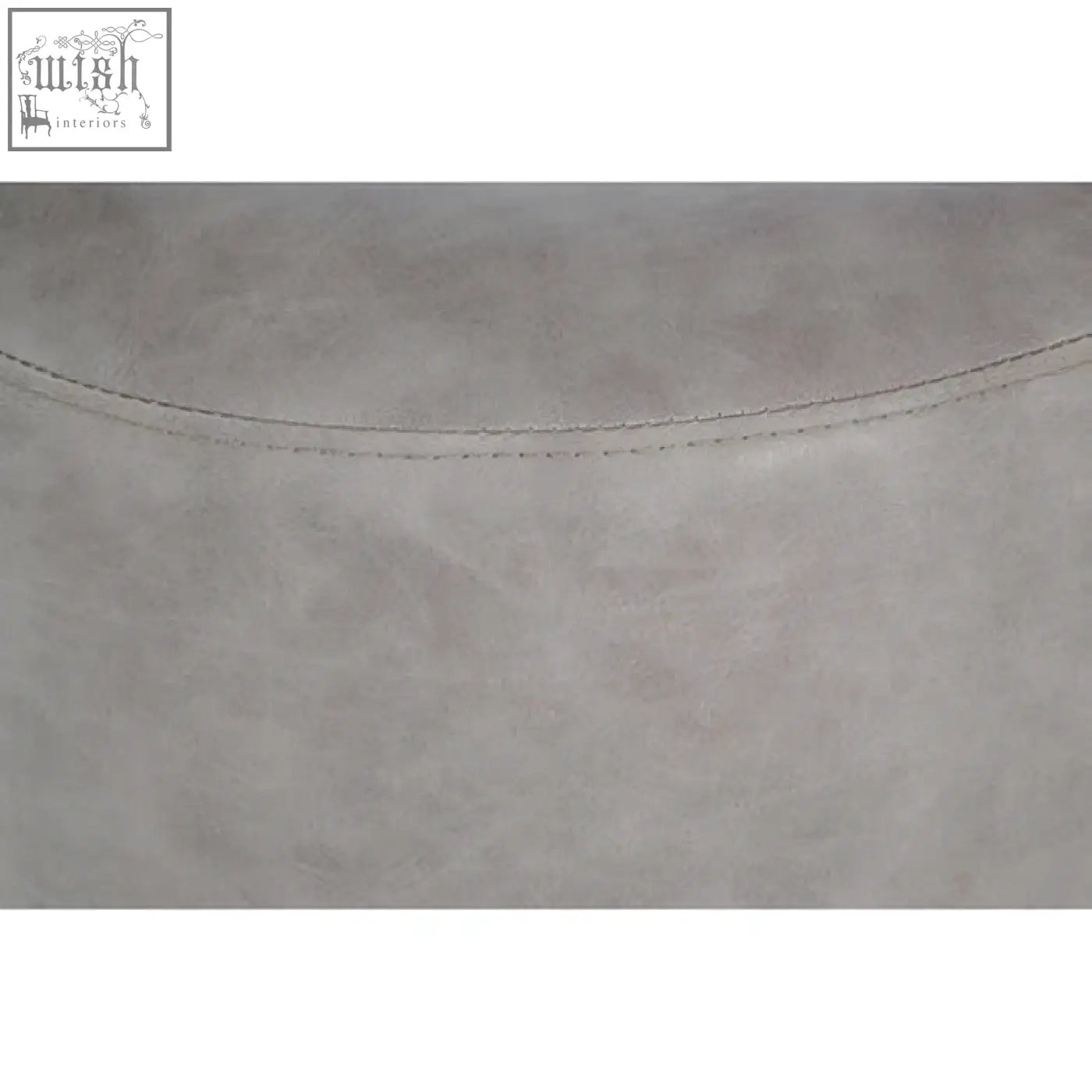 Light gray suede-like ash grey faux leather pouffe with subtle texture and fine stitching along curved edge