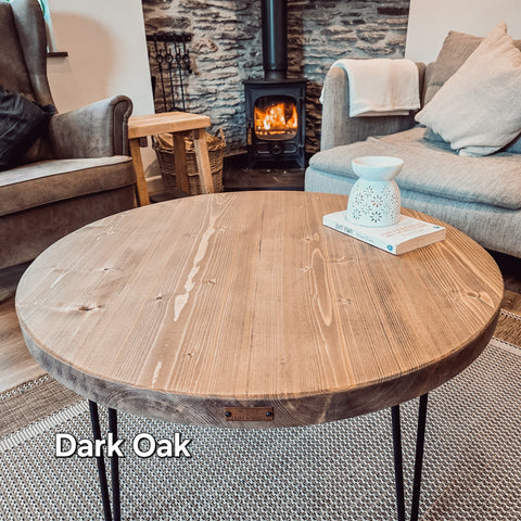 Dark oak dalva round coffee table with slender black metal legs for stylish living room use