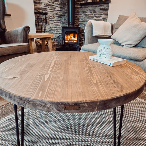 Rustic dalva round coffee table with natural wood top and black metal legs perfect for any living room