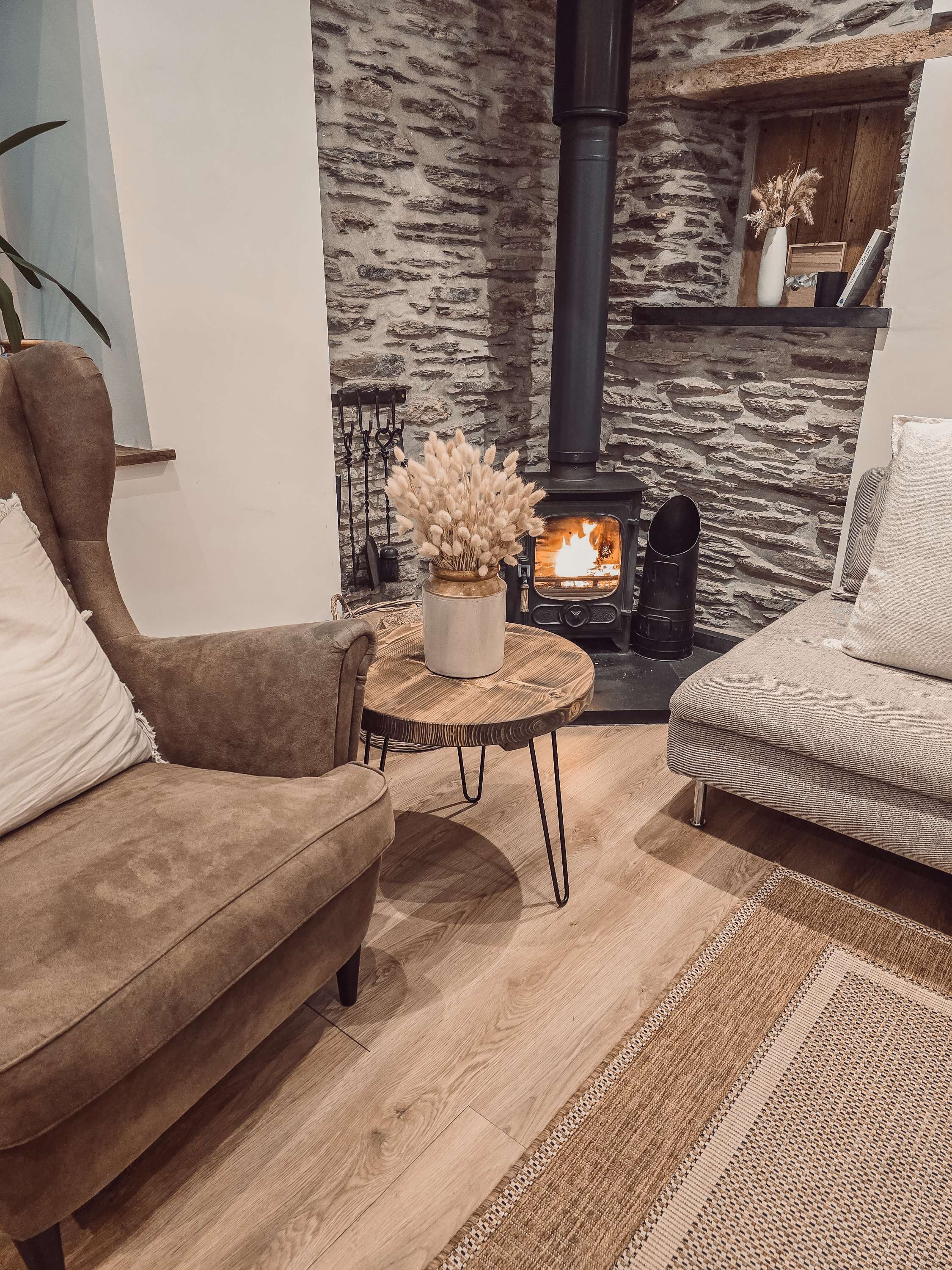 Dalva walnut round coffee table with rustic wooden top and black metal legs is a stylish round coffee table