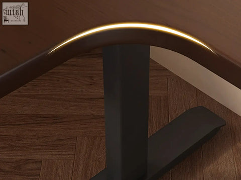 The damico electric standing office desk features a curved dark brown wooden edge with a sleek golden light strip