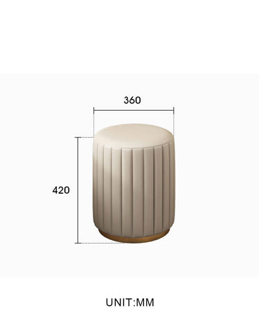 Cream-colored upholstered cylindrical stool with vertical pleats and gold base for damion dressing table setup