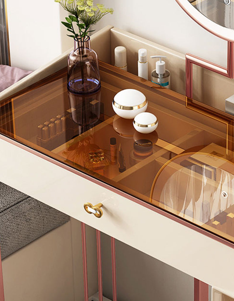 Modern damion dressing table with translucent amber glass top cream body and rose gold metal frame accents