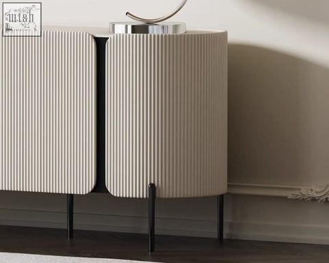 Beige ribbed damon sideboard with sleek black legs and polished chrome top accent perfect blend for dining area