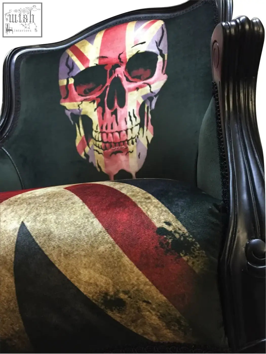 Dark green velvet dan gold union skull arm chair with bold skull back design and black lacquered frame shown from back