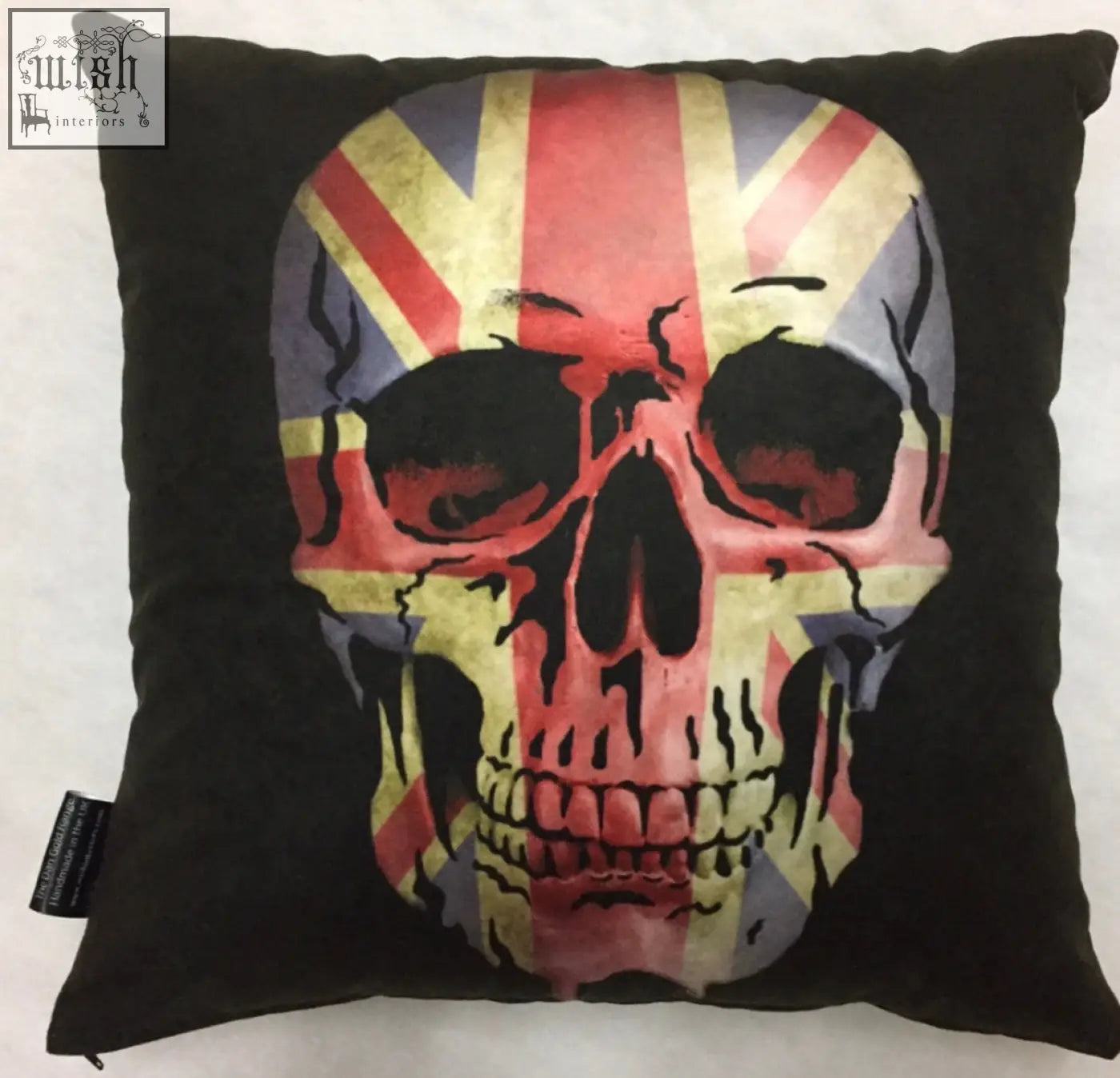 Black cushion with a distressed union jack skull design by dan gold perfect for edgy home decor